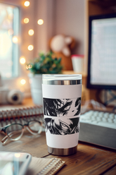 a coffee cup sitting on top of a wooden desk