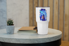 a white cup sitting on top of a table next to a plant