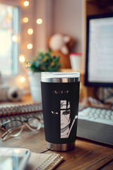 a coffee cup sitting on top of a wooden desk