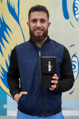 a man with a beard holding a tablet