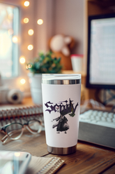 a coffee cup sitting on top of a wooden desk