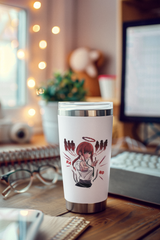 a cup sitting on a desk next to a computer