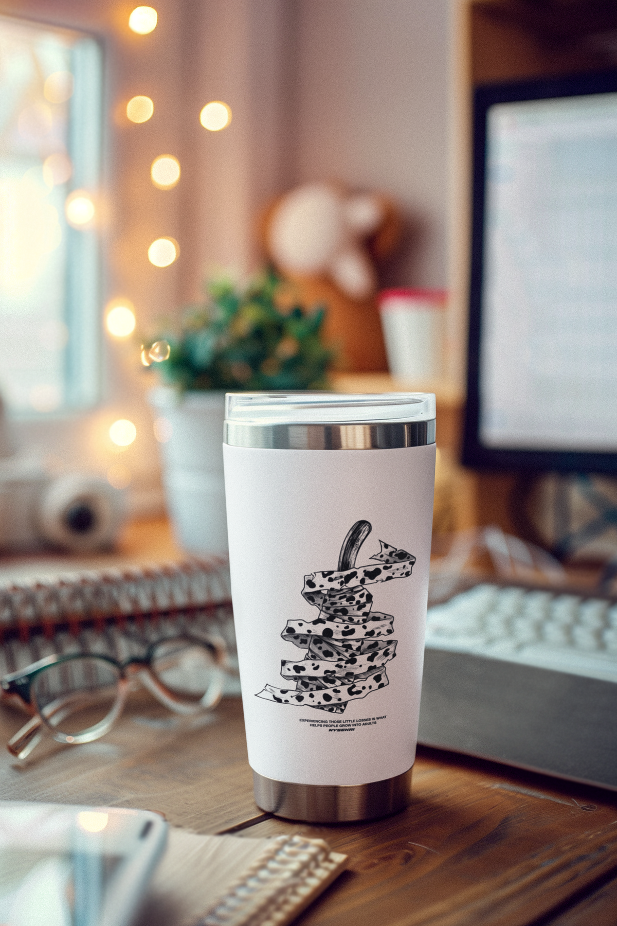 a coffee cup sitting on top of a wooden desk